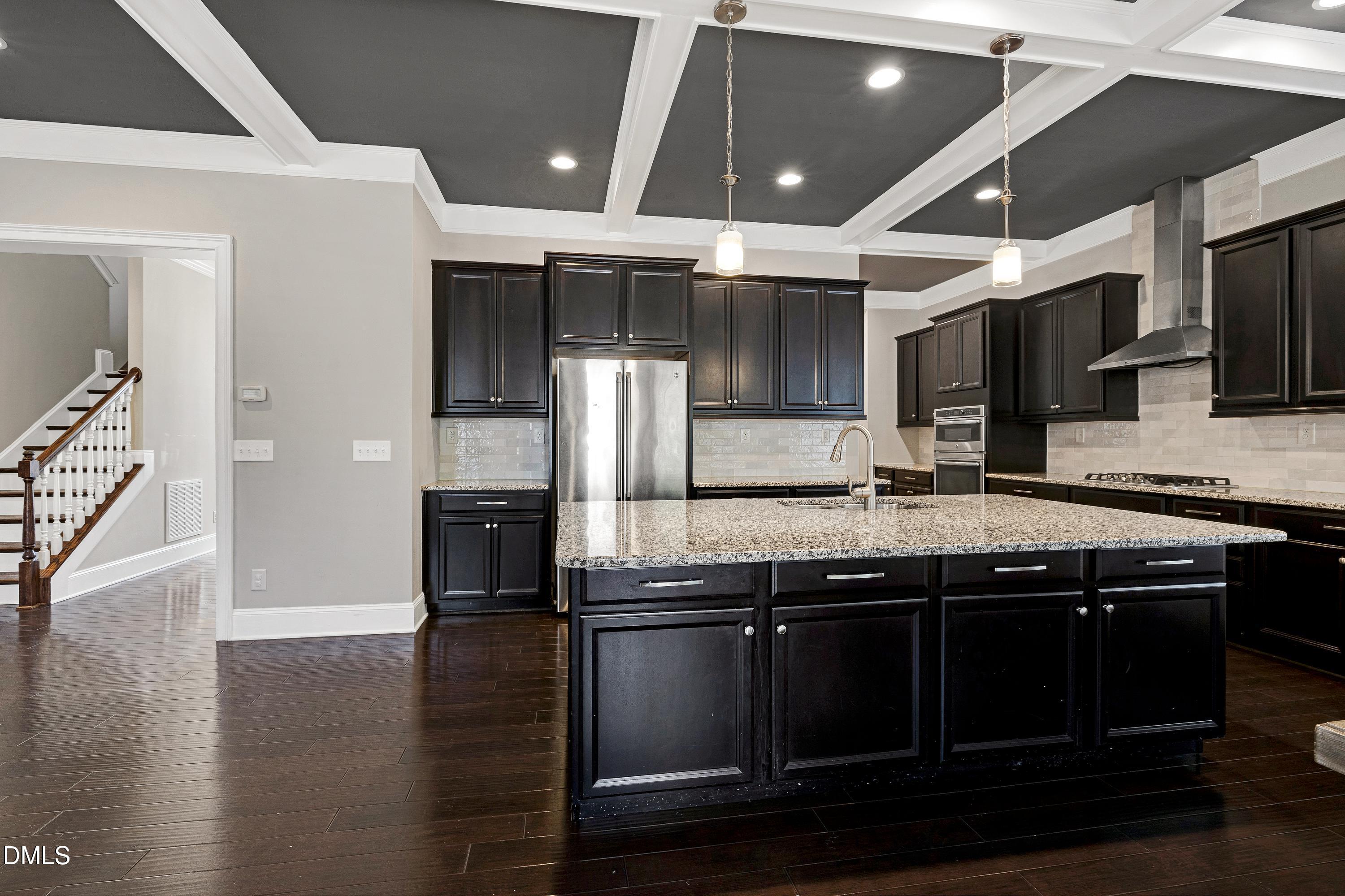 212 Mystic Pine Place Apex, NC 27539 - Photo 9 of 67 a kitchen with a sink stainless steel appliances and cabinets