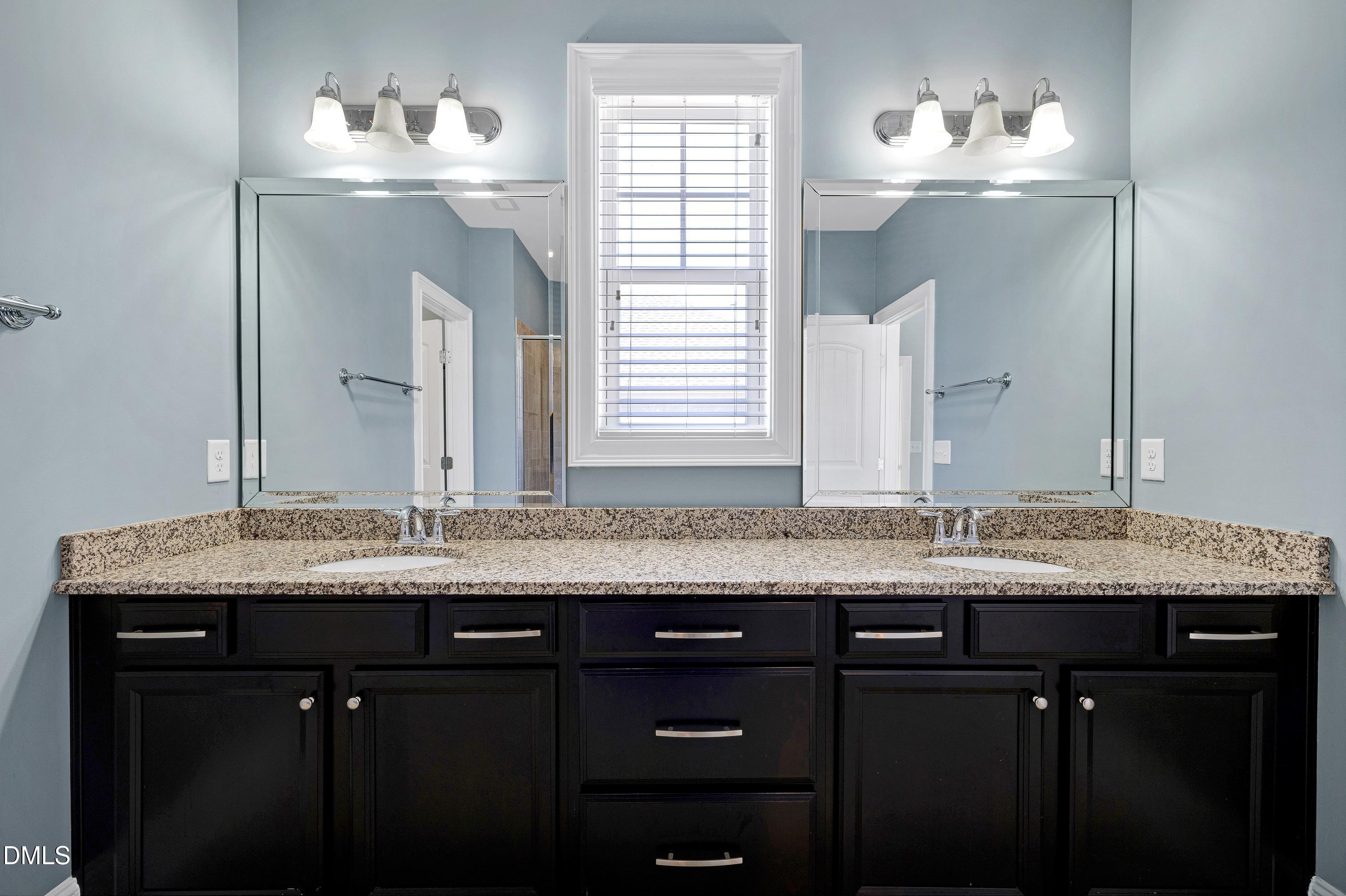 212 Mystic Pine Place Apex, NC 27539 - Photo 26 of 67 a bathroom with a granite countertop sink and a mirror