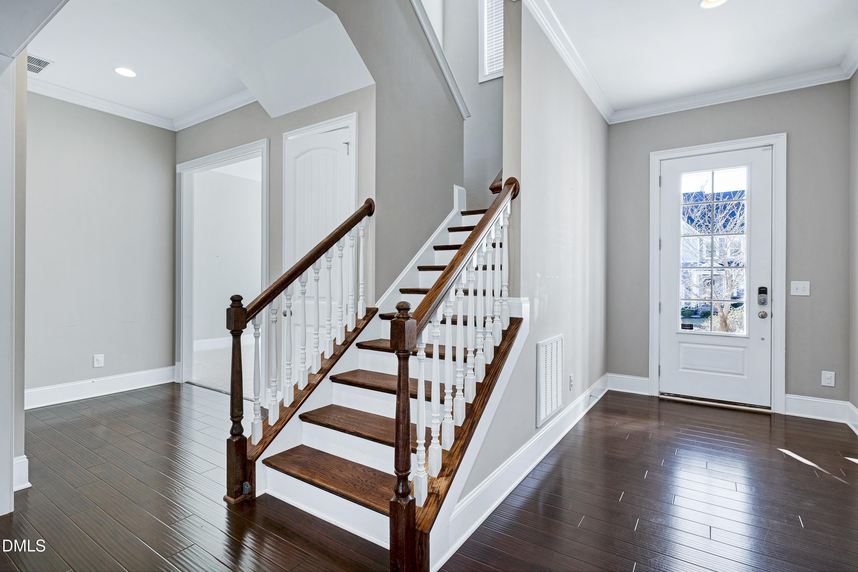 212 Mystic Pine Place Apex, NC 27539 - Photo 2 of 67 a view of entryway with wooden floor and stairs