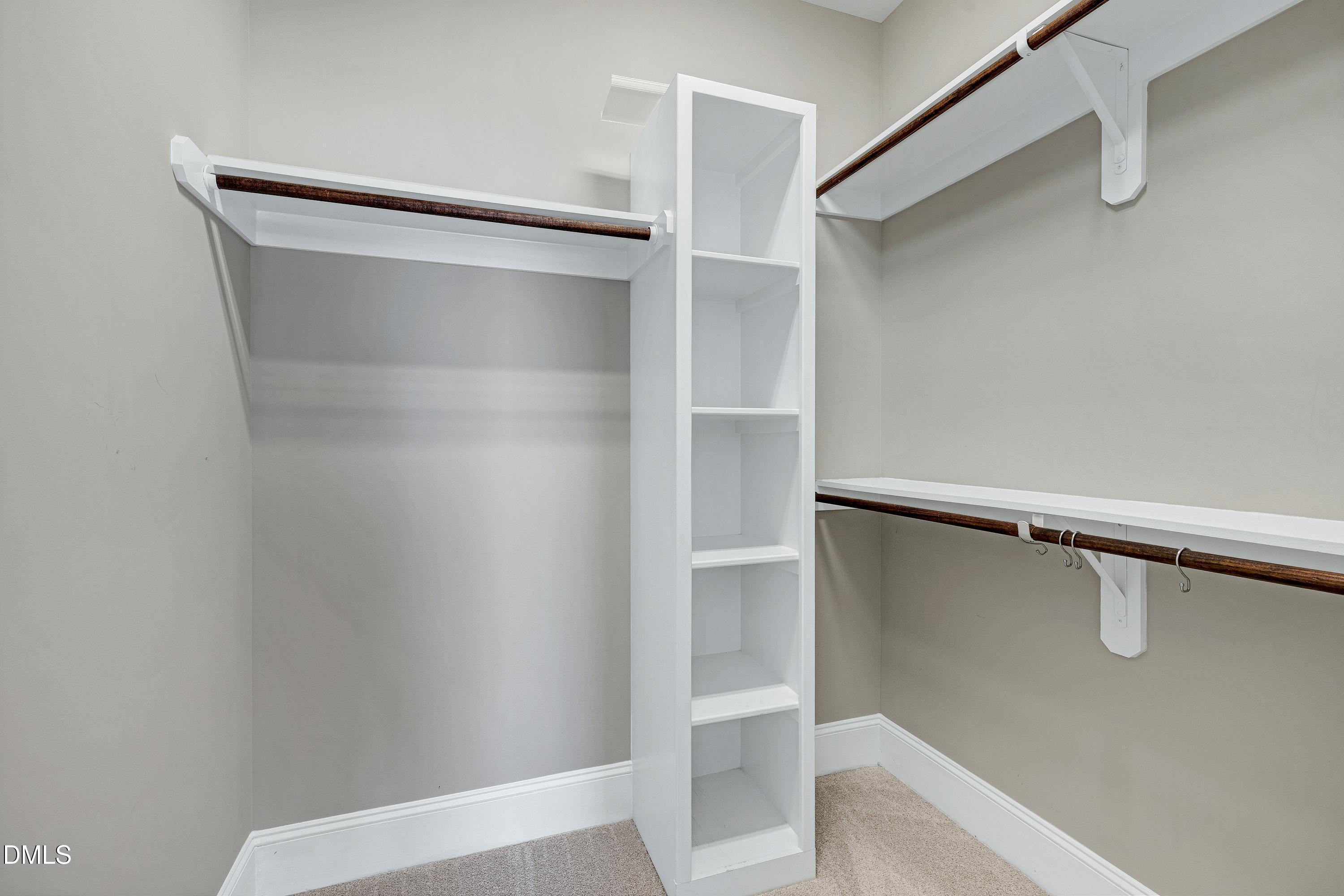 212 Mystic Pine Place Apex, NC 27539 - Photo 30 of 67 a view of walk in closet with empty racks