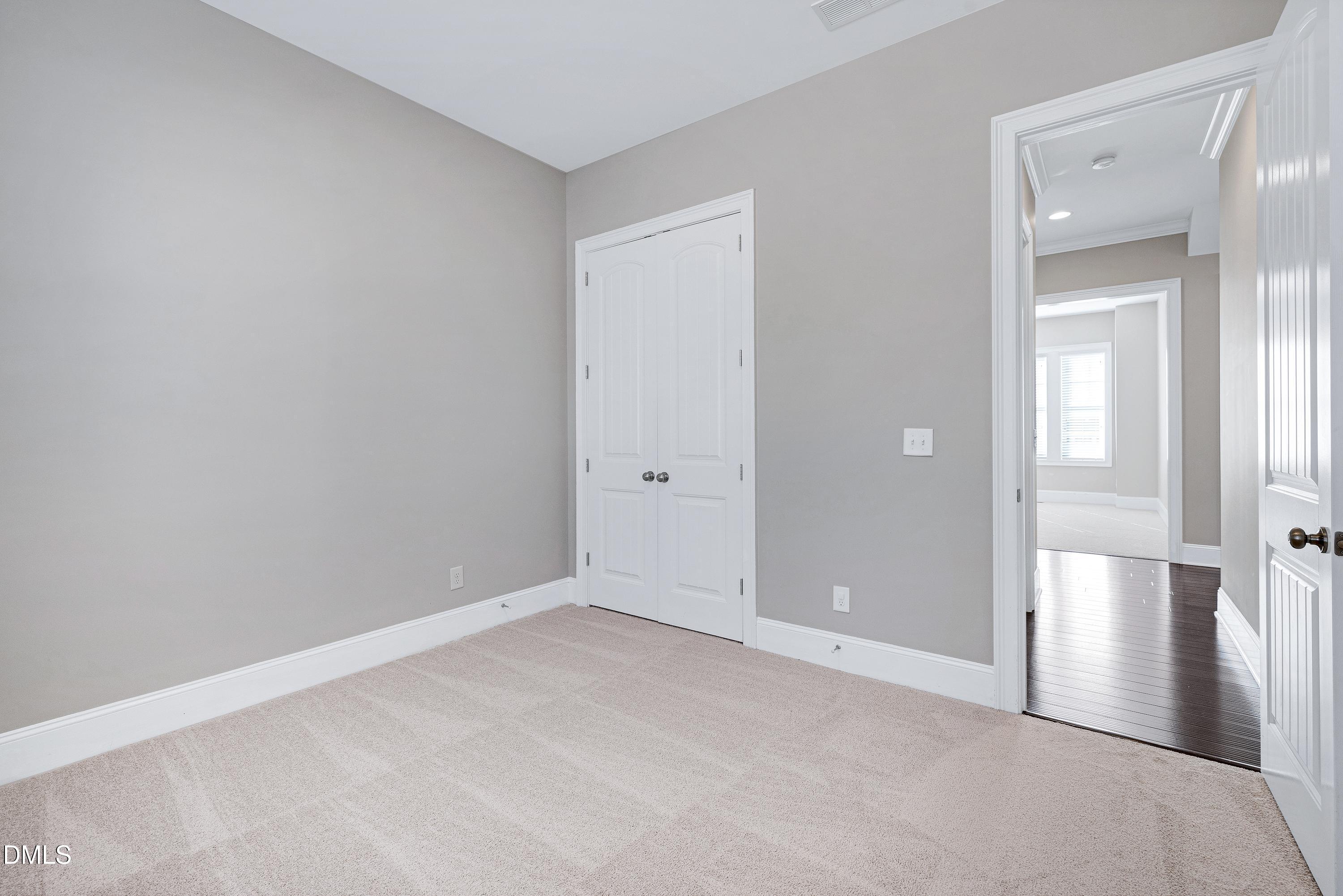 212 Mystic Pine Place Apex, NC 27539 - Photo 34 of 67 an empty room with windows and entrance to other room