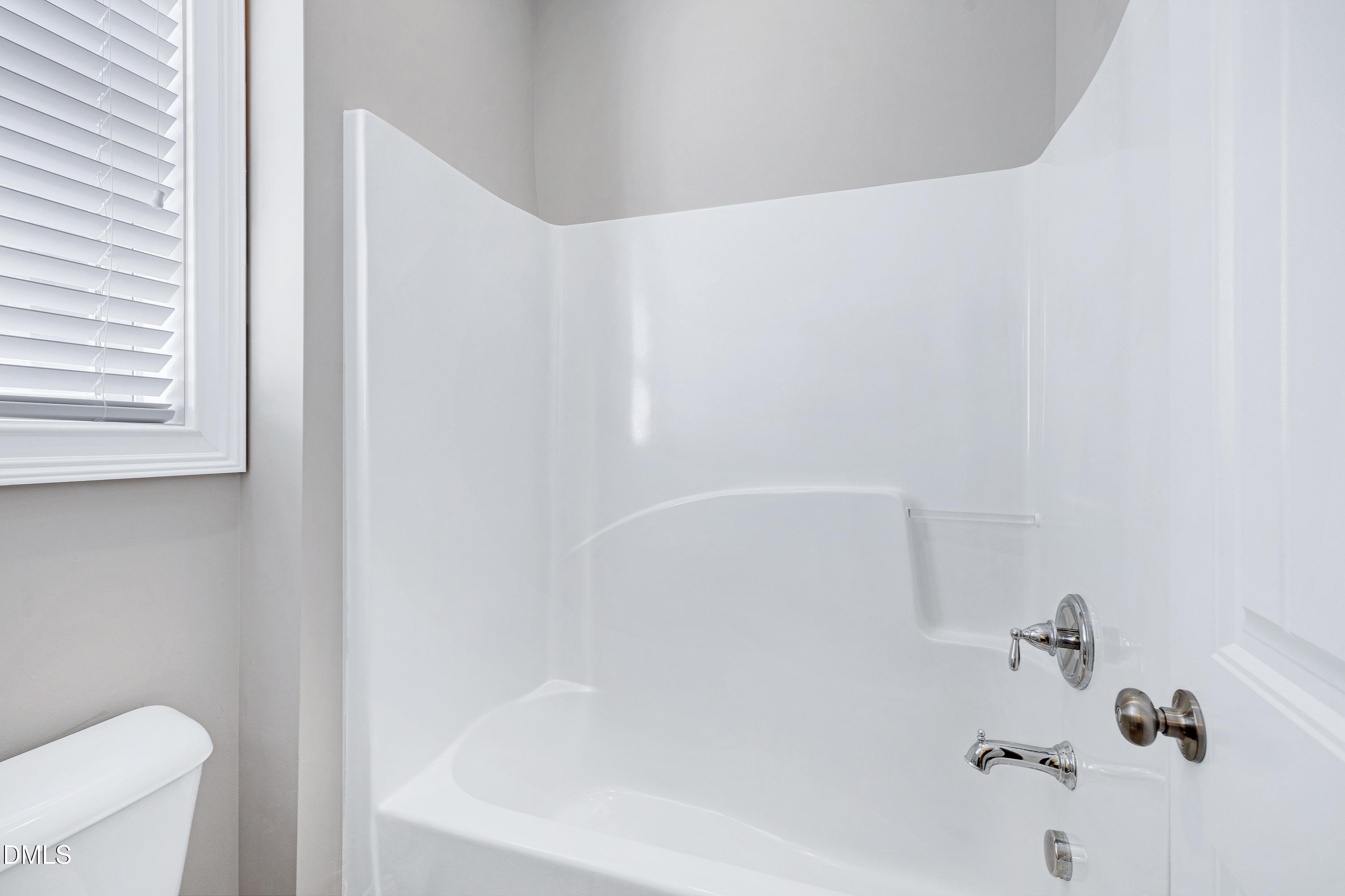 212 Mystic Pine Place Apex, NC 27539 - Photo 40 of 67 a bathroom with a bathtub