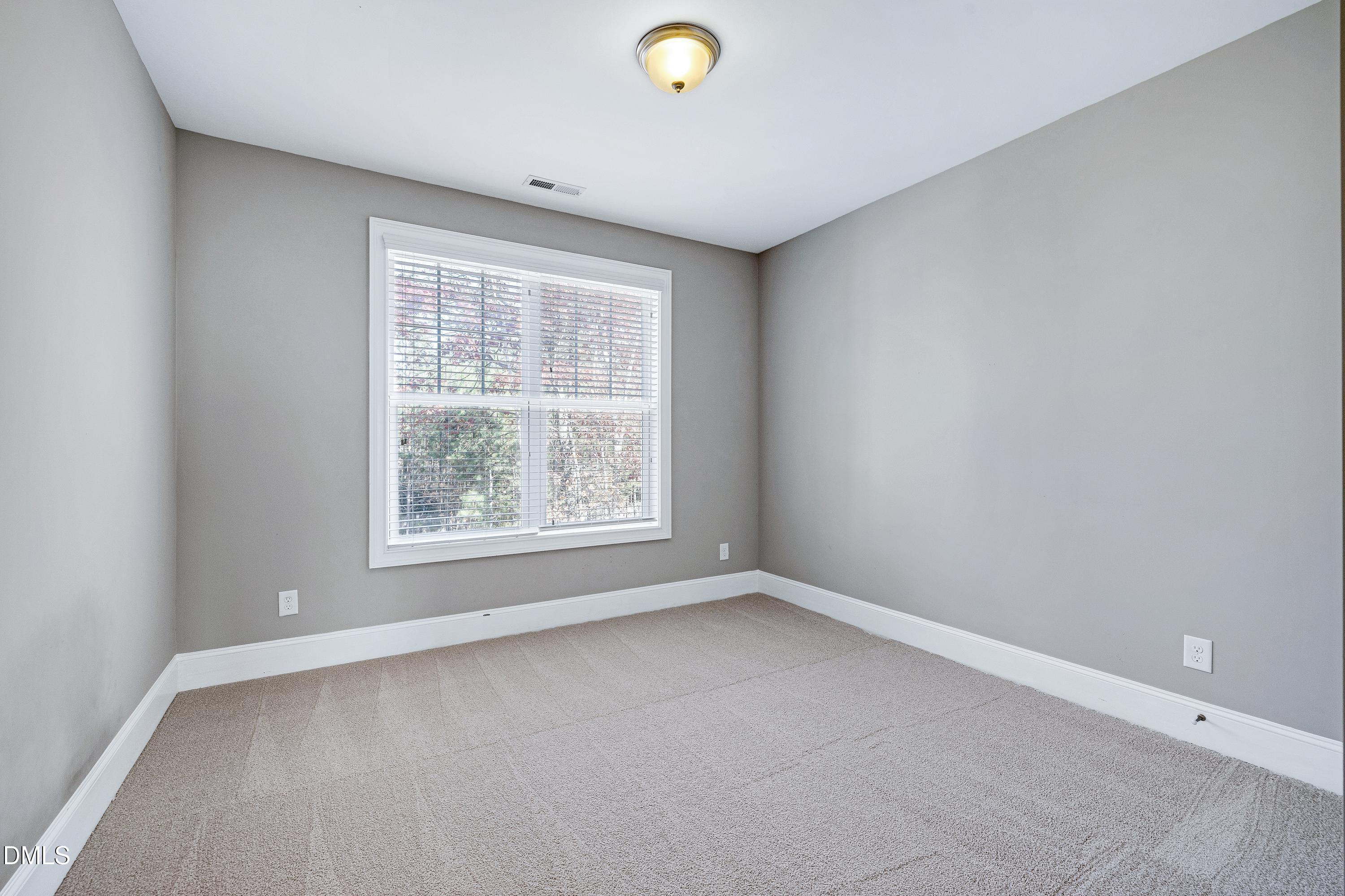 212 Mystic Pine Place Apex, NC 27539 - Photo 42 of 67 an empty room with a empty space and a window