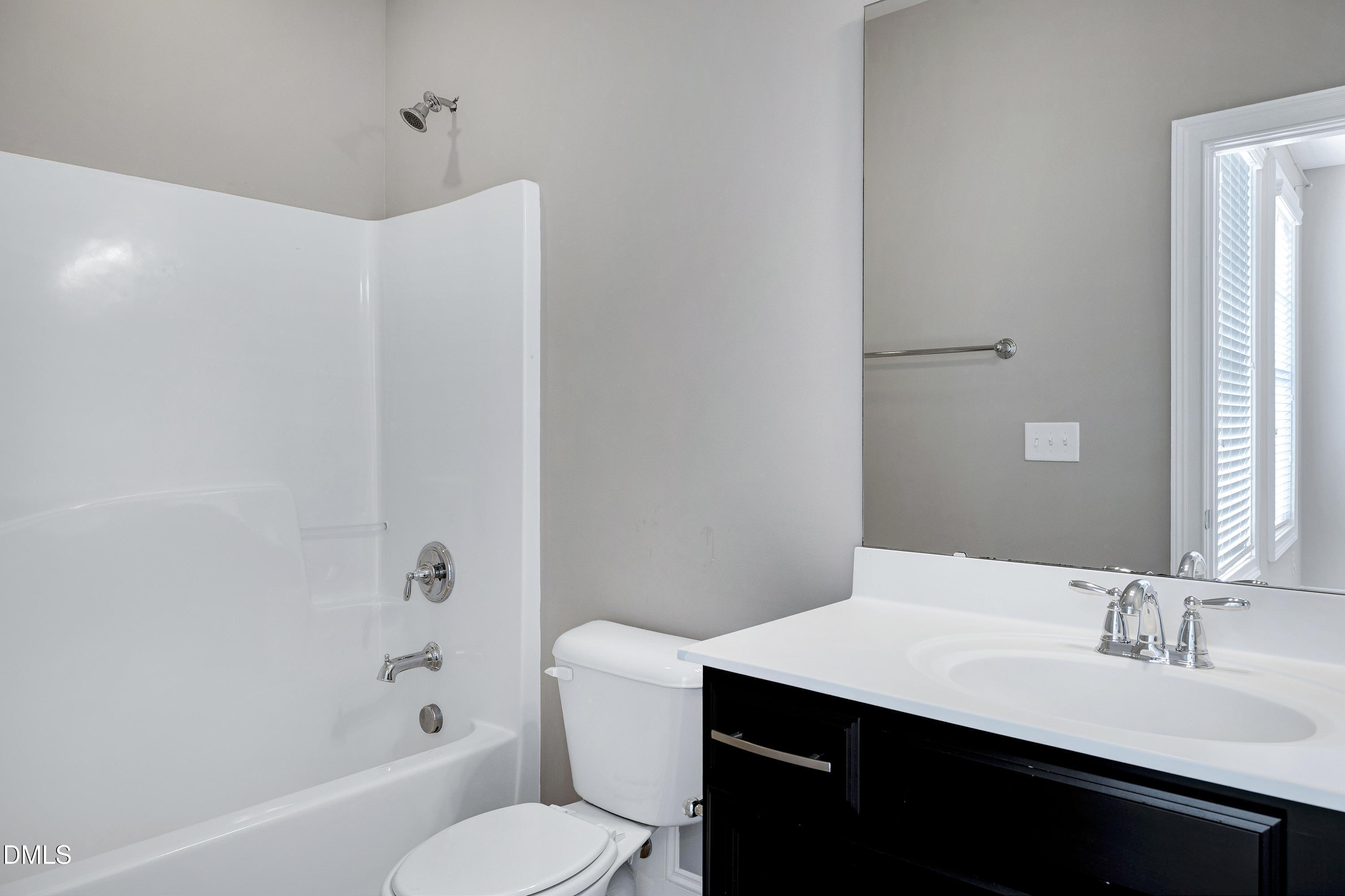 212 Mystic Pine Place Apex, NC 27539 - Photo 46 of 67 a bathroom with a sink a toilet a mirror and shower