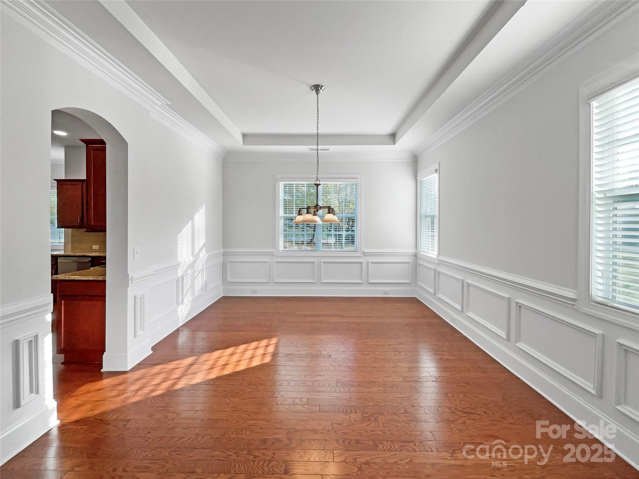 6615 Springs Mill Road Charlotte, NC 28277 - Photo 11 of 23 a view of an empty room with window and wooden floor