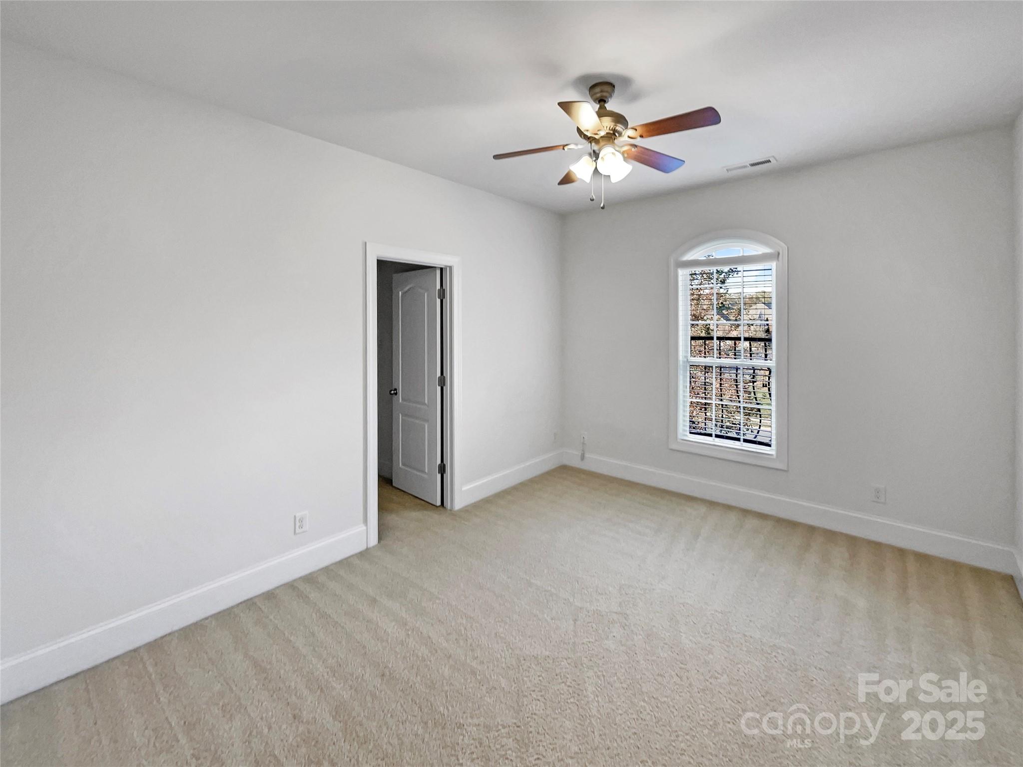 6615 Springs Mill Road Charlotte, NC 28277 - Photo 16 of 23 an empty room with windows and fan