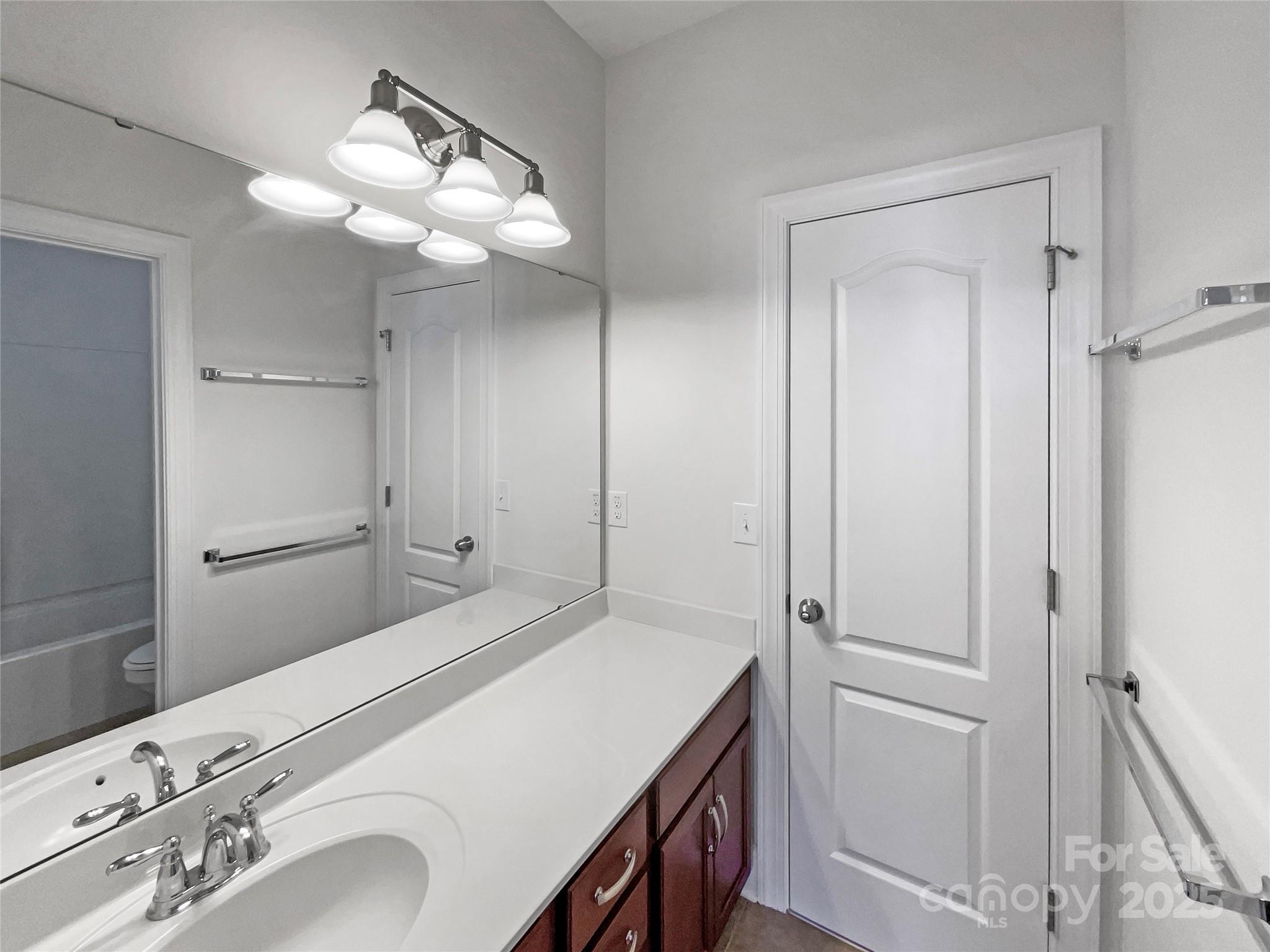 6615 Springs Mill Road Charlotte, NC 28277 - Photo 19 of 23 a bedroom with a bed and a chandelier