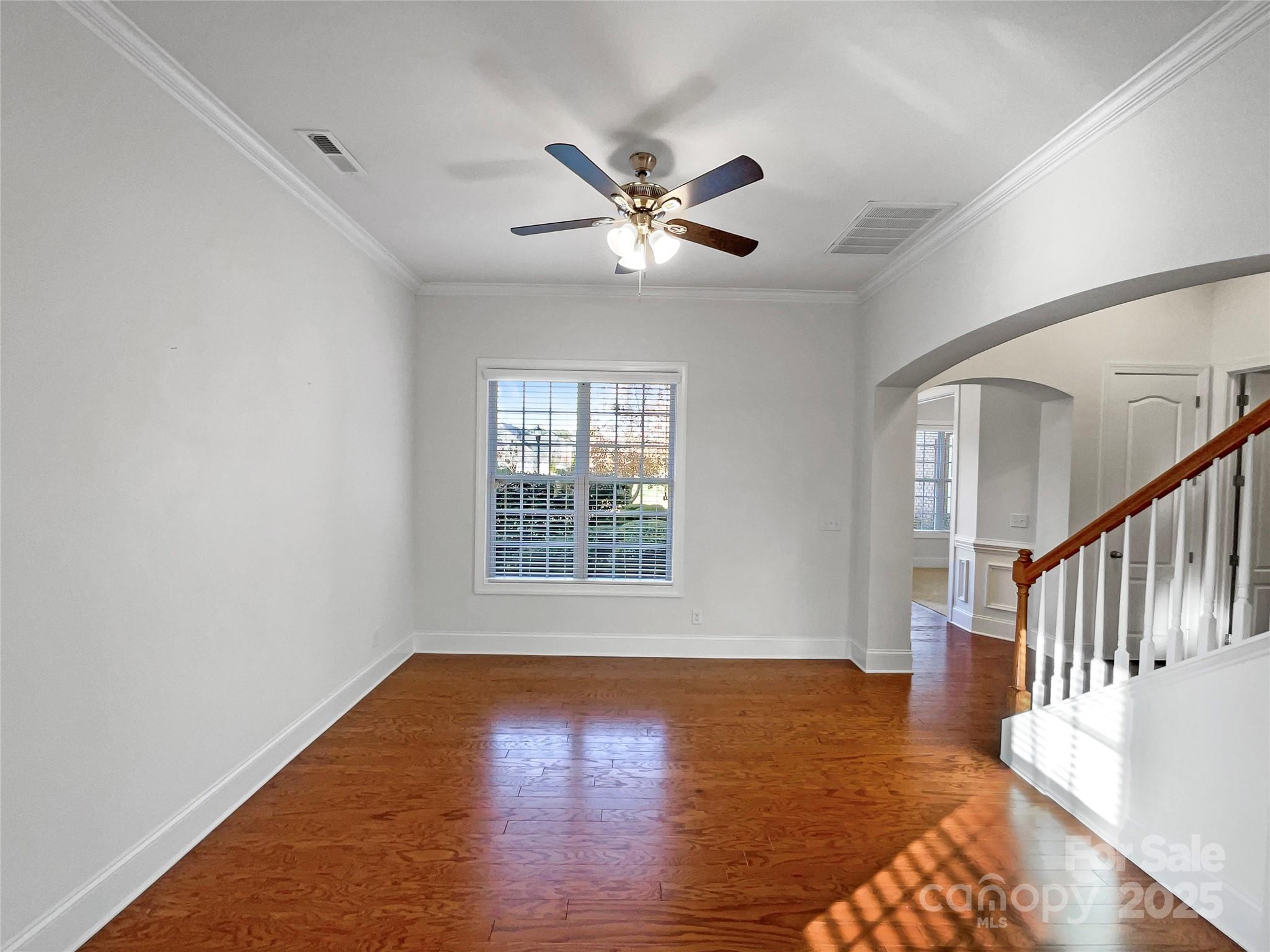 6615 Springs Mill Road Charlotte, NC 28277 - Photo 4 of 23 a view of an empty room with wooden floor and a window