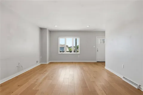 a kitchen with stainless steel appliances granite countertop a refrigerator a sink dishwasher a stove and a wooden floors