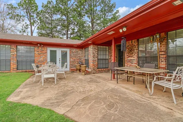 a view of a house with backyard and sitting area