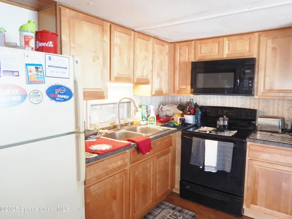 a kitchen with a refrigerator stove and microwave