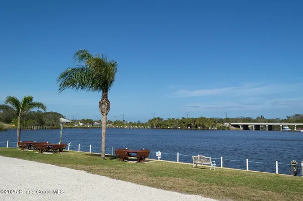 a view of a lake with boats and trees in the background