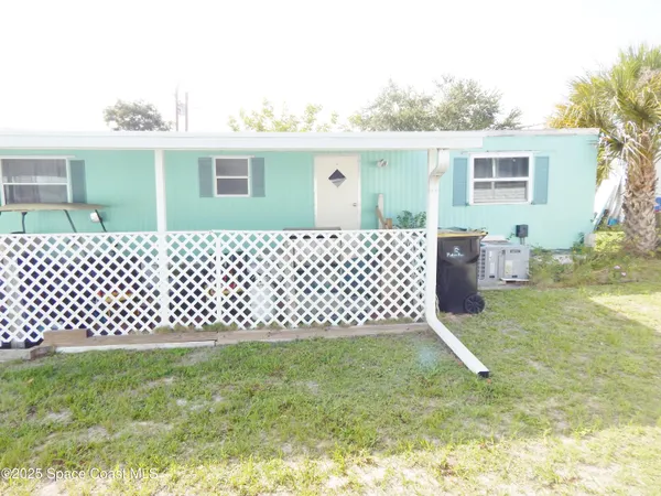a backyard of a house with wooden fence