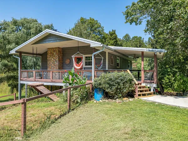 a view of a house with backyard and sitting area