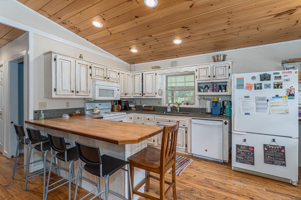 264 Tommy's Lane Murphy, NC 28906 - Photo 12 of 53 a kitchen with stainless steel appliances granite countertop a table chairs sink and cabinets