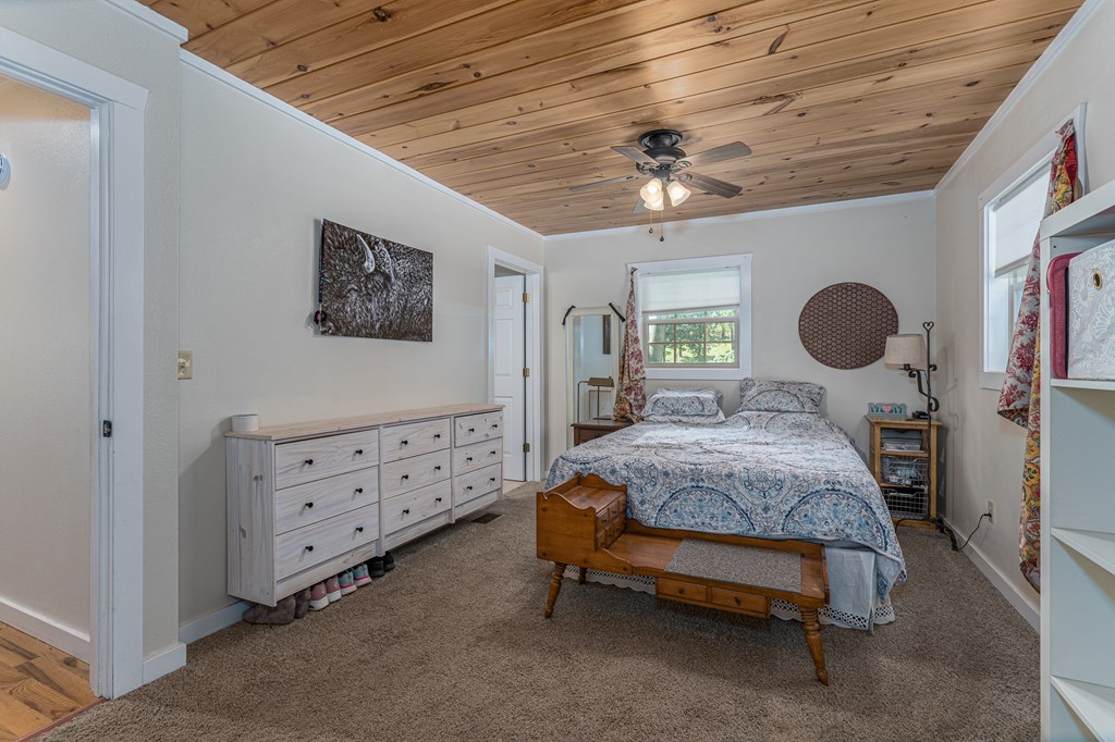 264 Tommy's Lane Murphy, NC 28906 - Photo 22 of 53 a bedroom with a bed and a chandelier