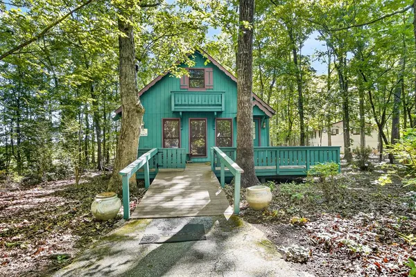 a front view of a house with a yard and porch