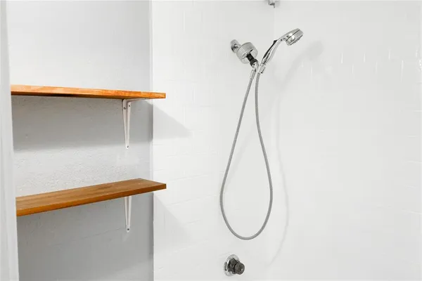 a bathroom with a shower and a mirror