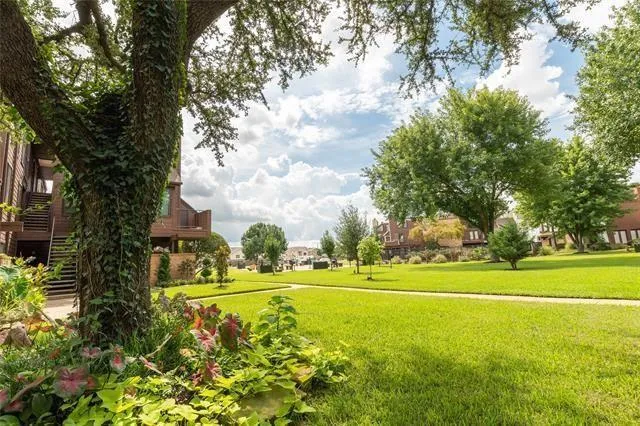 a view of a house with a yard and lake view