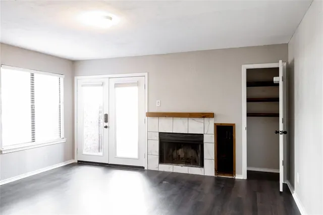 a view of a livingroom with a fireplace and window