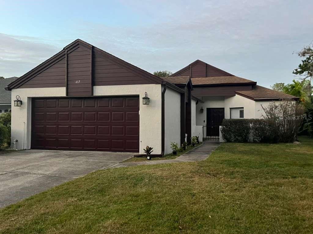 a front view of a house with a yard