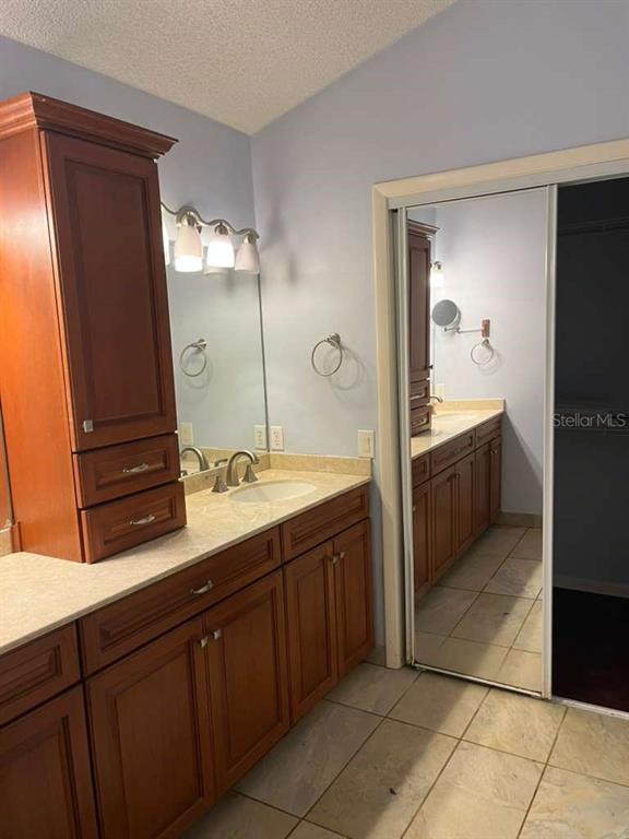 417 Greenfield Road Winter Haven, FL 33884 - Photo 11 of 15 a spacious bathroom with a double vanity sink and a mirror