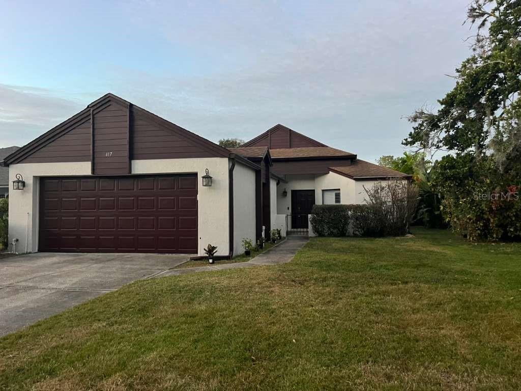 417 Greenfield Road Winter Haven, FL 33884 - Photo 2 of 15 a front view of a house with a yard