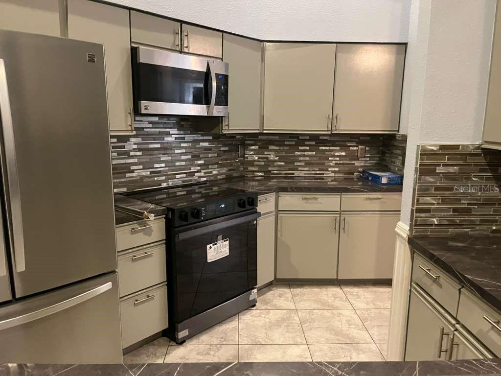 417 Greenfield Road Winter Haven, FL 33884 - Photo 6 of 15 a kitchen with stainless steel appliances granite countertop a stove and a microwave