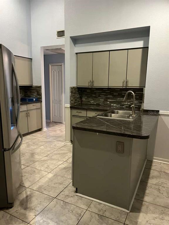 417 Greenfield Road Winter Haven, FL 33884 - Photo 8 of 15 a kitchen with stainless steel appliances granite countertop a stove a refrigerator and a sink
