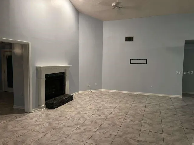 a view of empty room with a fireplace
