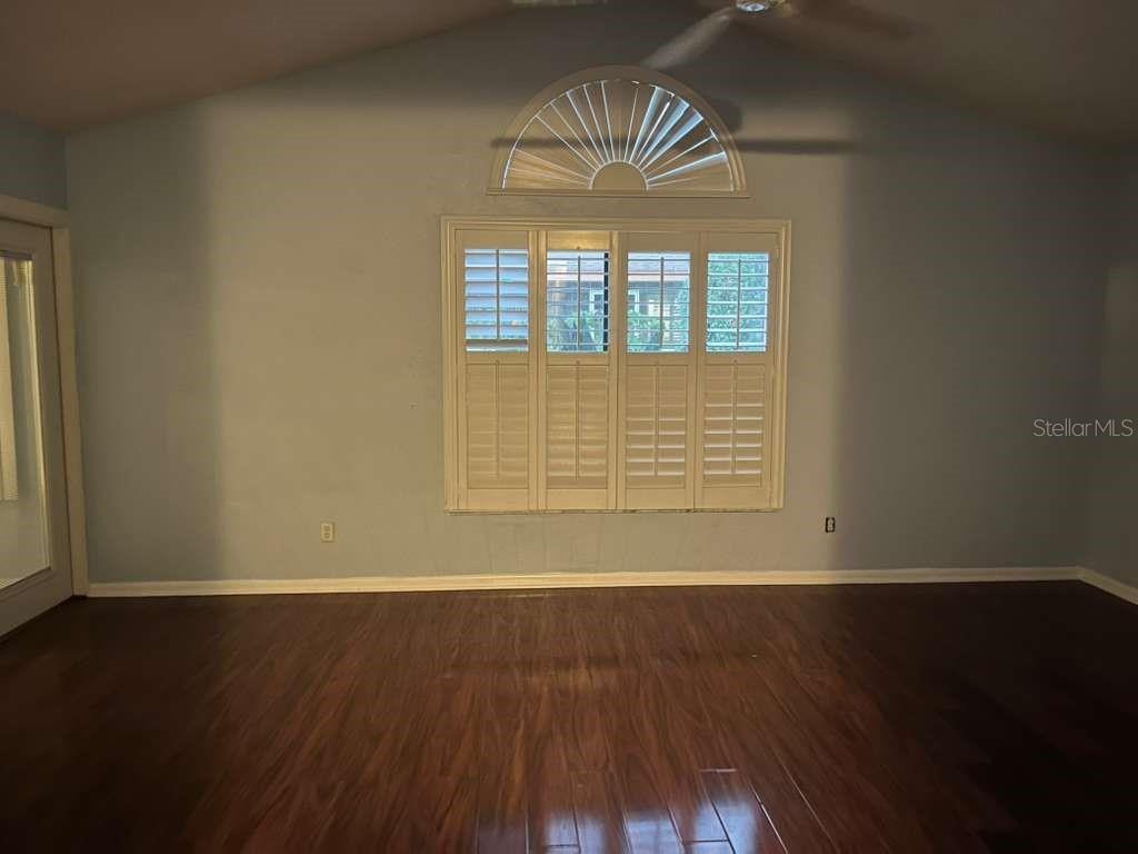 417 Greenfield Road Winter Haven, FL 33884 - Photo 10 of 15 an empty room with wooden floor and windows