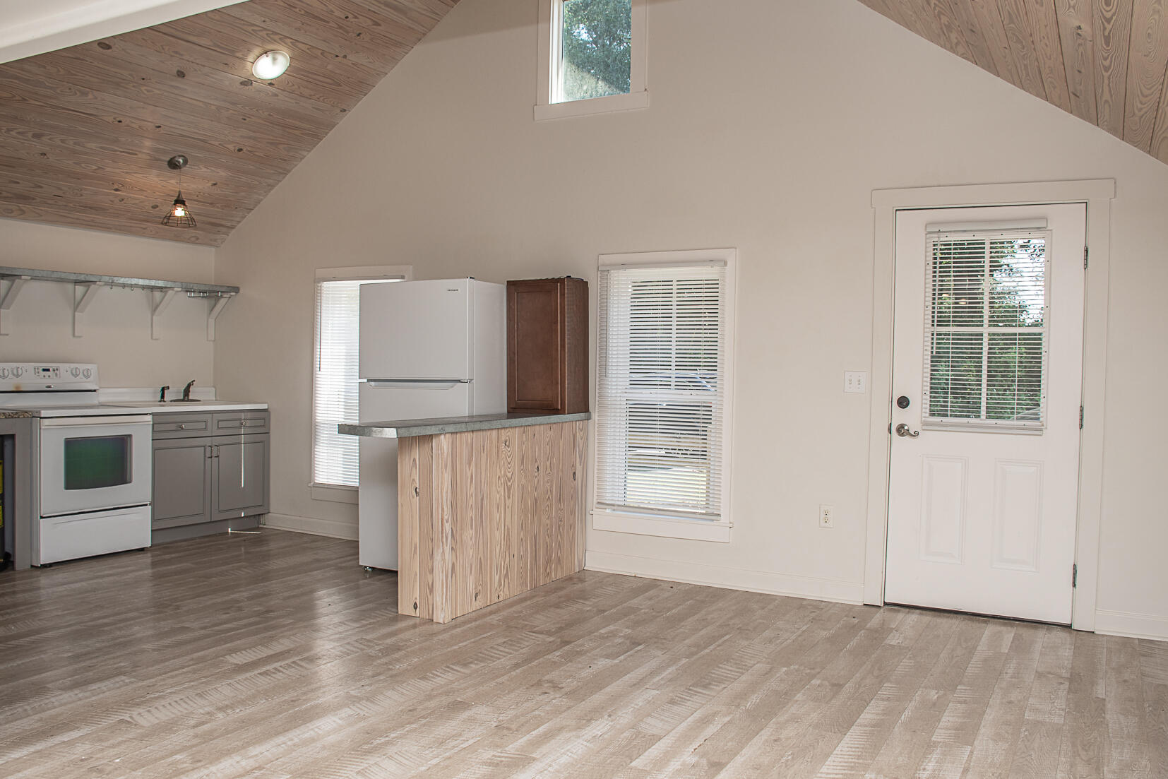 452 North Spring Street Crestview, FL 32536 - Photo 6 of 11 a kitchen with stainless steel appliances granite countertop a stove a sink and a refrigerator with wooden floors