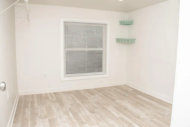 a view of an empty room with a window