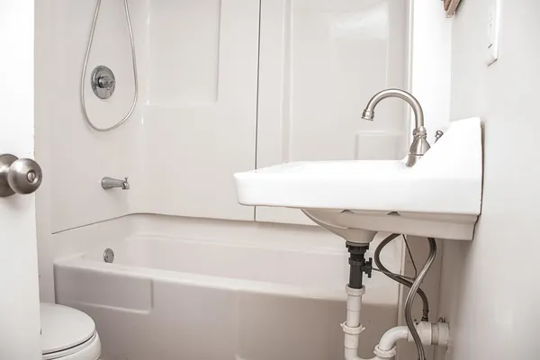a white bath tub sitting next to a white sink