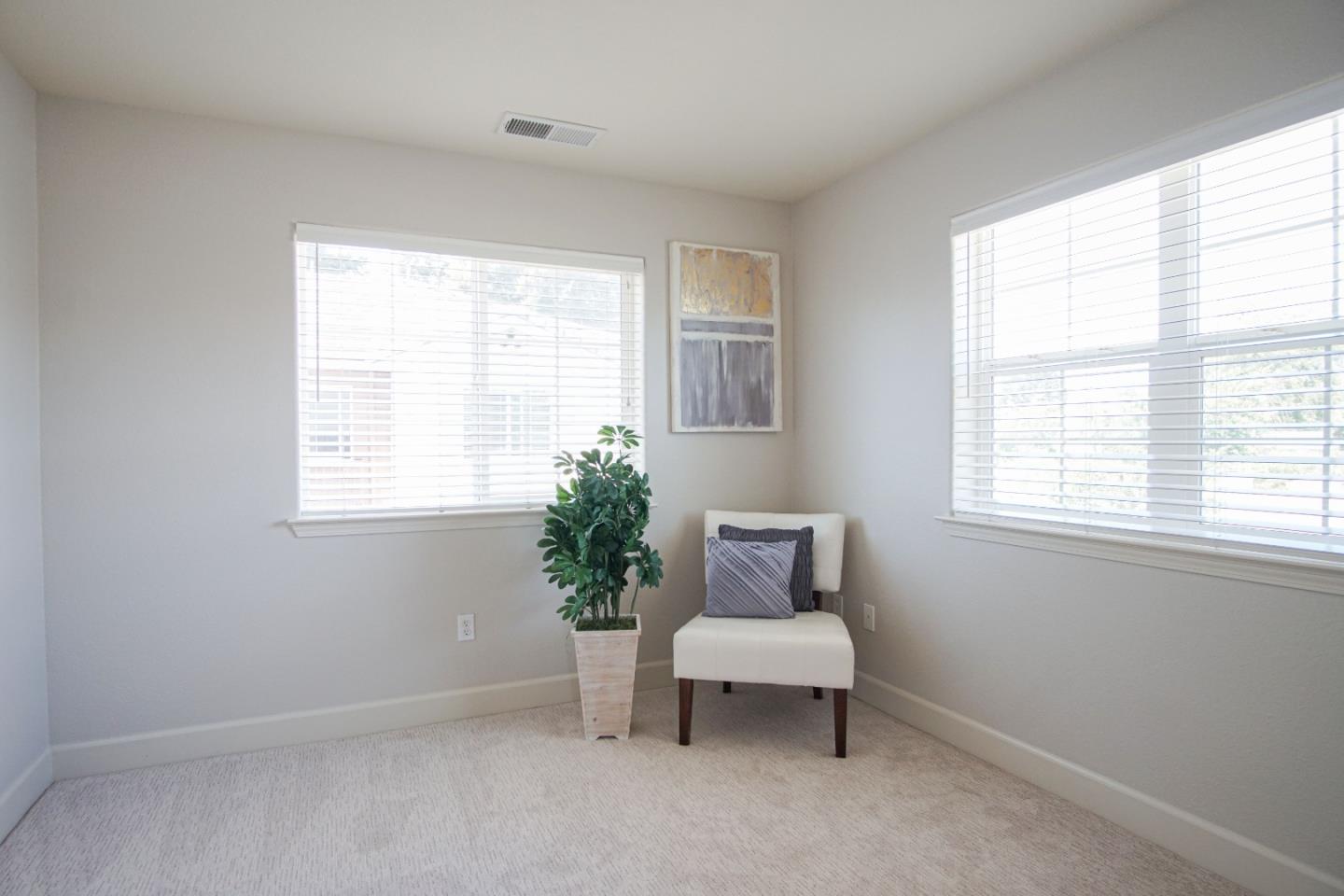 3906 Borgo Common Fremont, CA 94538 - Photo 14 of 21 a white chair sitting in a bedroom next to a window
