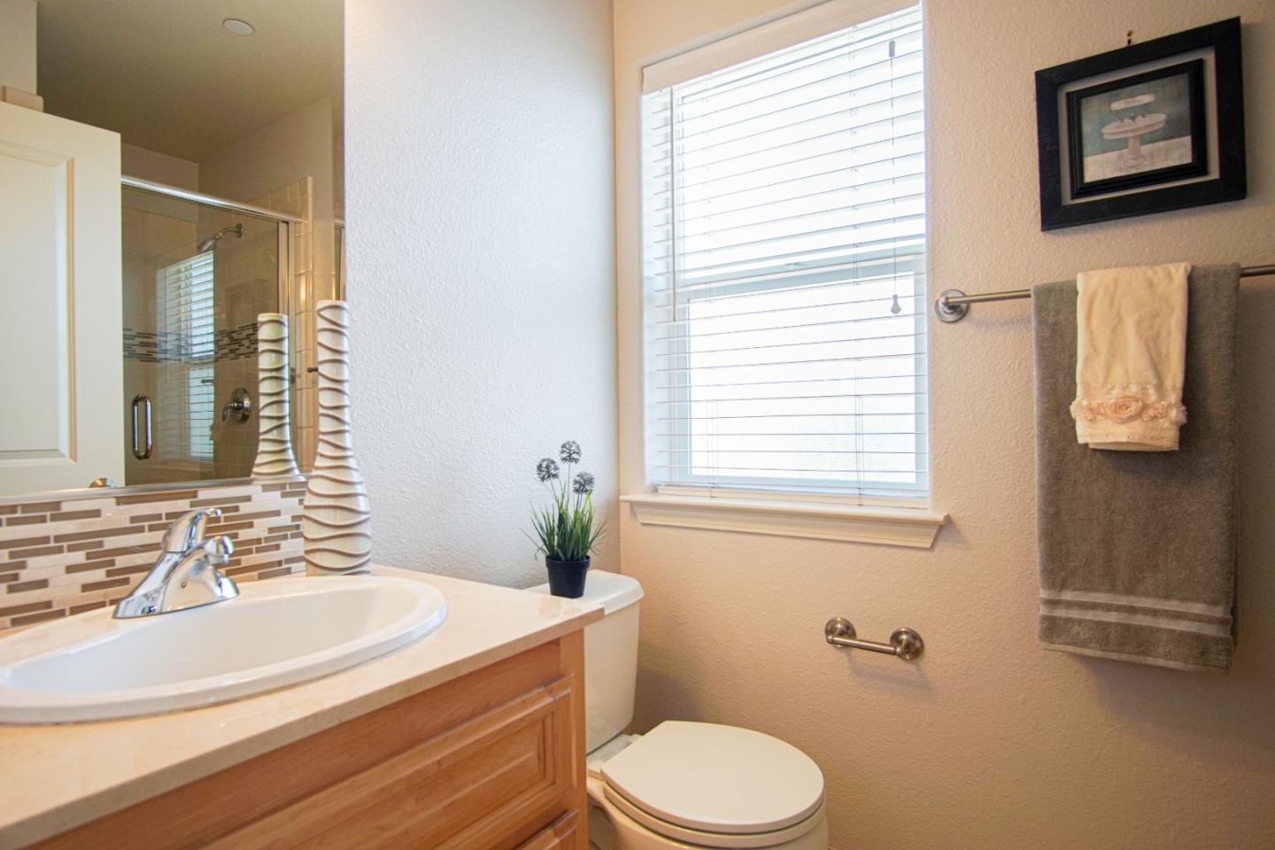 3906 Borgo Common Fremont, CA 94538 - Photo 15 of 21 a bathroom with a sink a toilet and tub