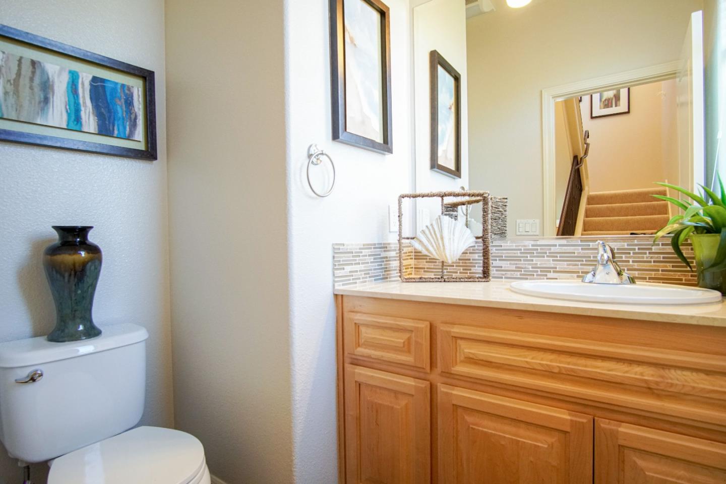 3906 Borgo Common Fremont, CA 94538 - Photo 16 of 21 a bathroom with a granite countertop toilet sink and mirror