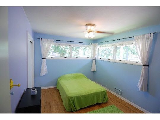 4224 Pinecrest Road Rockford, IL 61107 - Photo 8 of 11 a bedroom with a bed and a chandelier