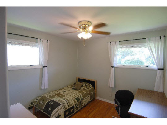 4224 Pinecrest Road Rockford, IL 61107 - Photo 9 of 11 a bedroom with a bed and a chandelier