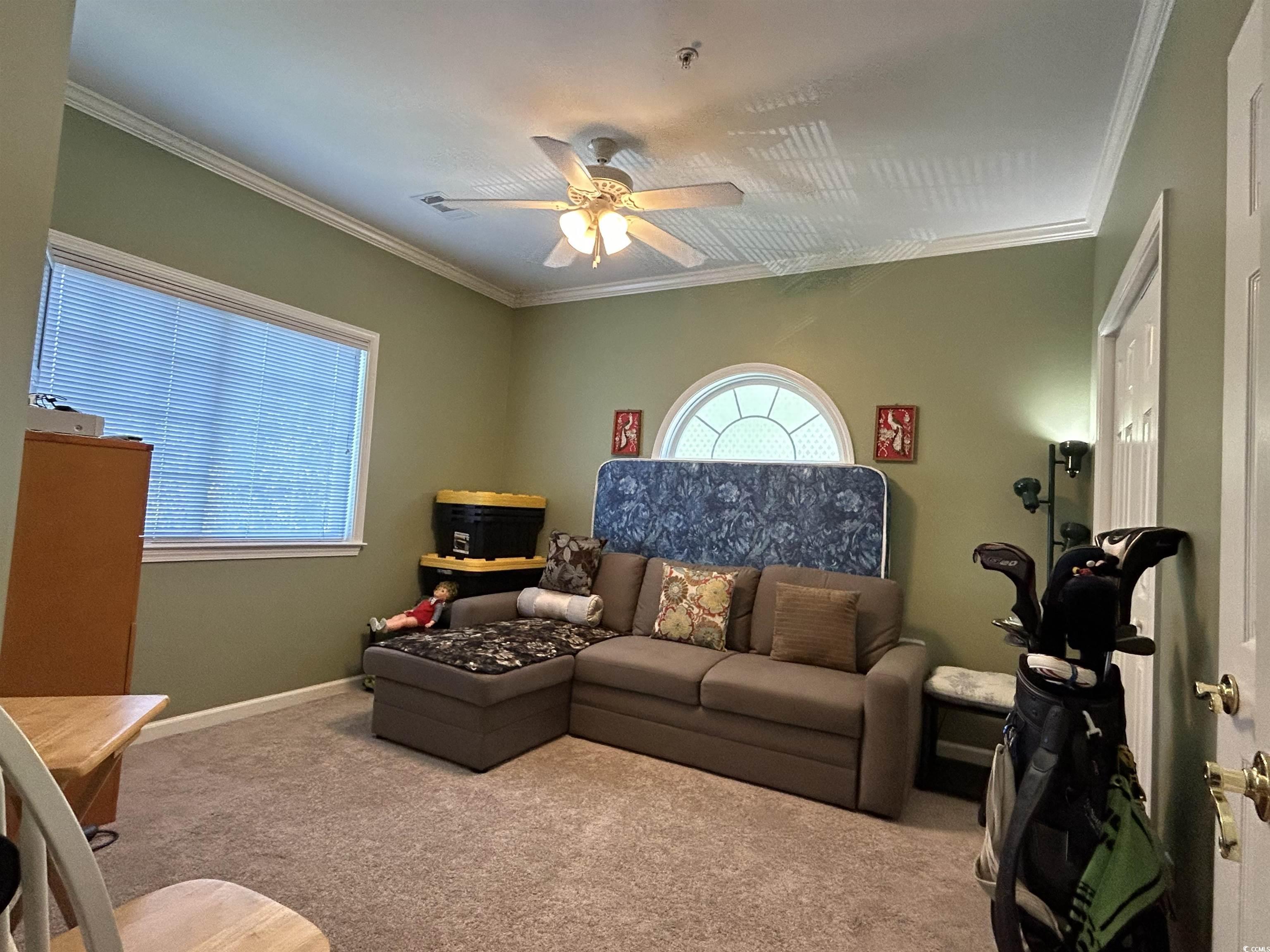1525 Lanterns Rest Road, Unit 301 Myrtle Beach, SC 29579 - Photo 11 of 34 Carpeted living room with ceiling fan and ornamental molding