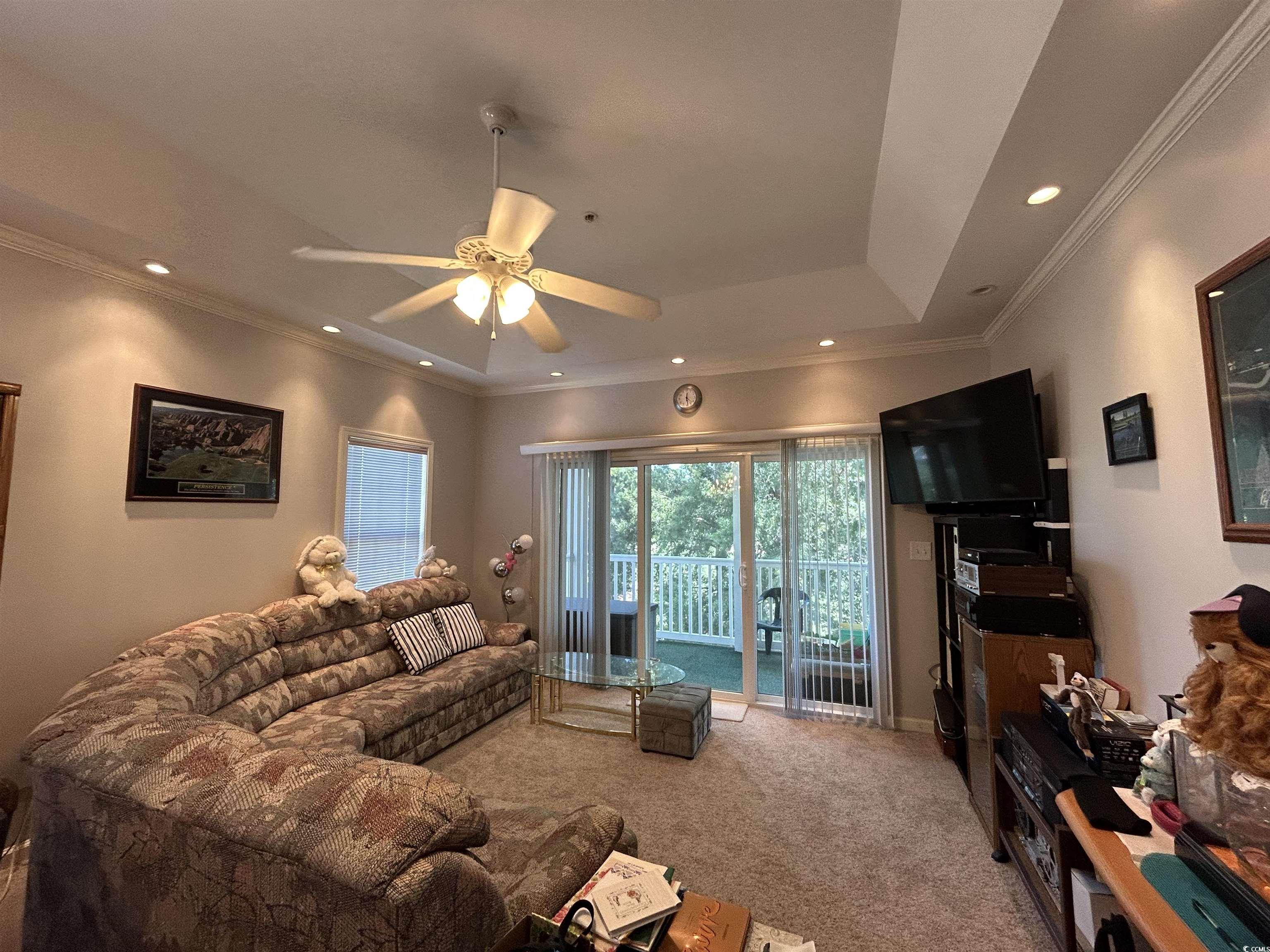 1525 Lanterns Rest Road, Unit 301 Myrtle Beach, SC 29579 - Photo 5 of 34 Living room with crown molding, carpet floors, and ceiling fan