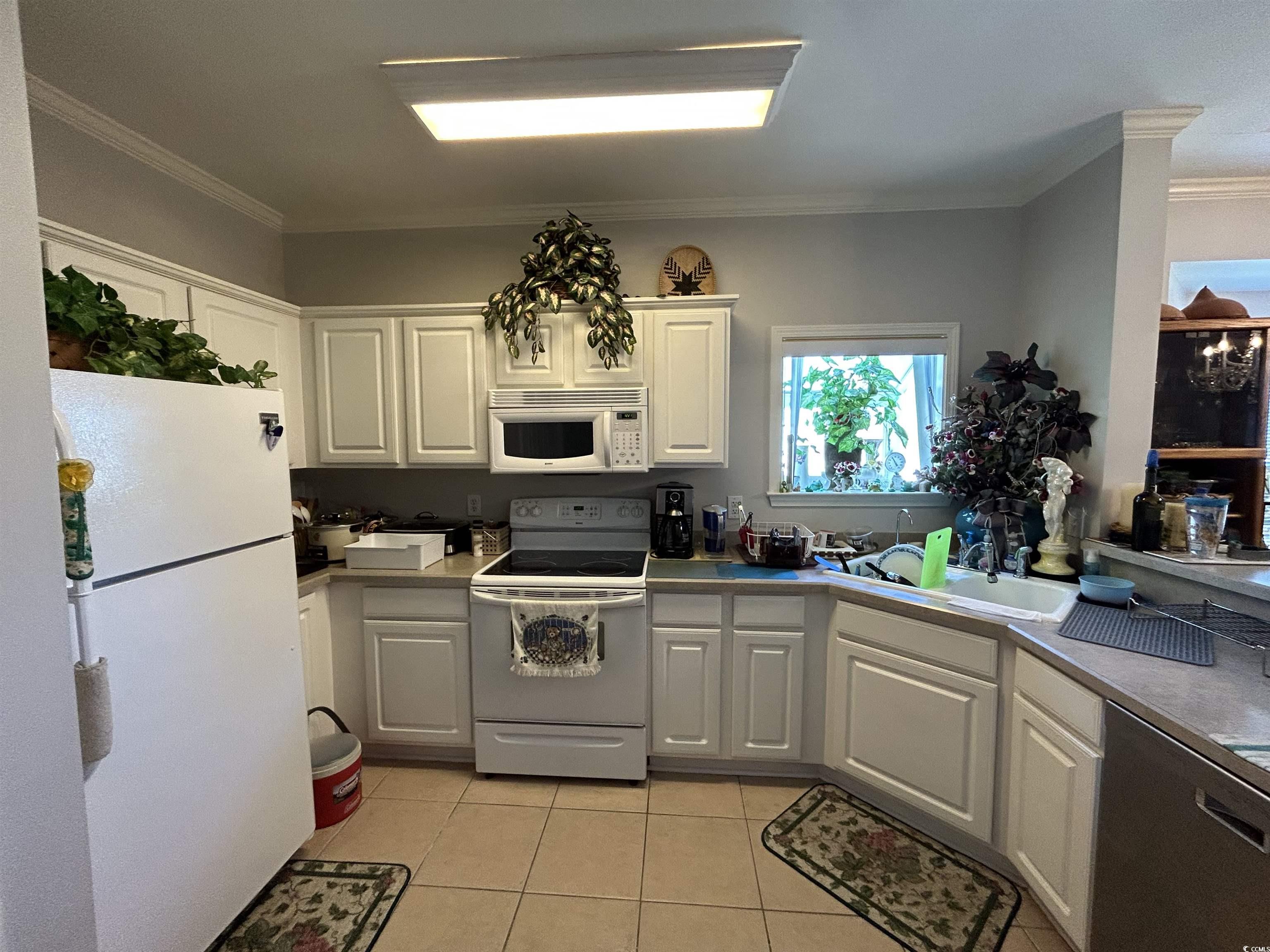 1525 Lanterns Rest Road, Unit 301 Myrtle Beach, SC 29579 - Photo 6 of 34 Kitchen featuring white appliances, white cabinetry, ornamental molding, and sink