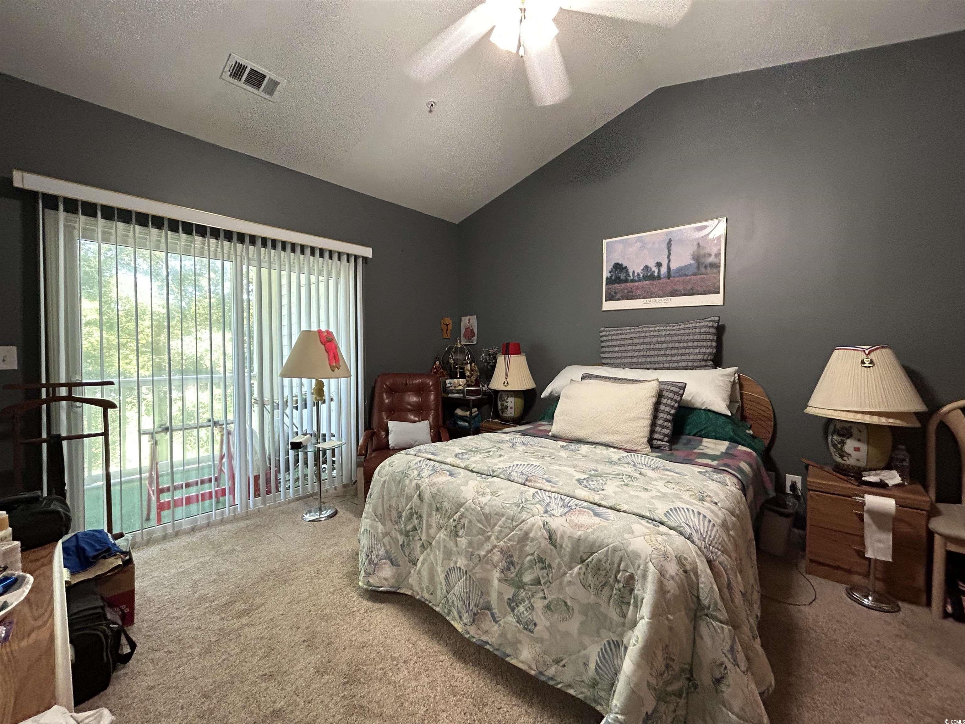 1525 Lanterns Rest Road, Unit 301 Myrtle Beach, SC 29579 - Photo 8 of 34 Carpeted bedroom with vaulted ceiling, a textured ceiling, and ceiling fan