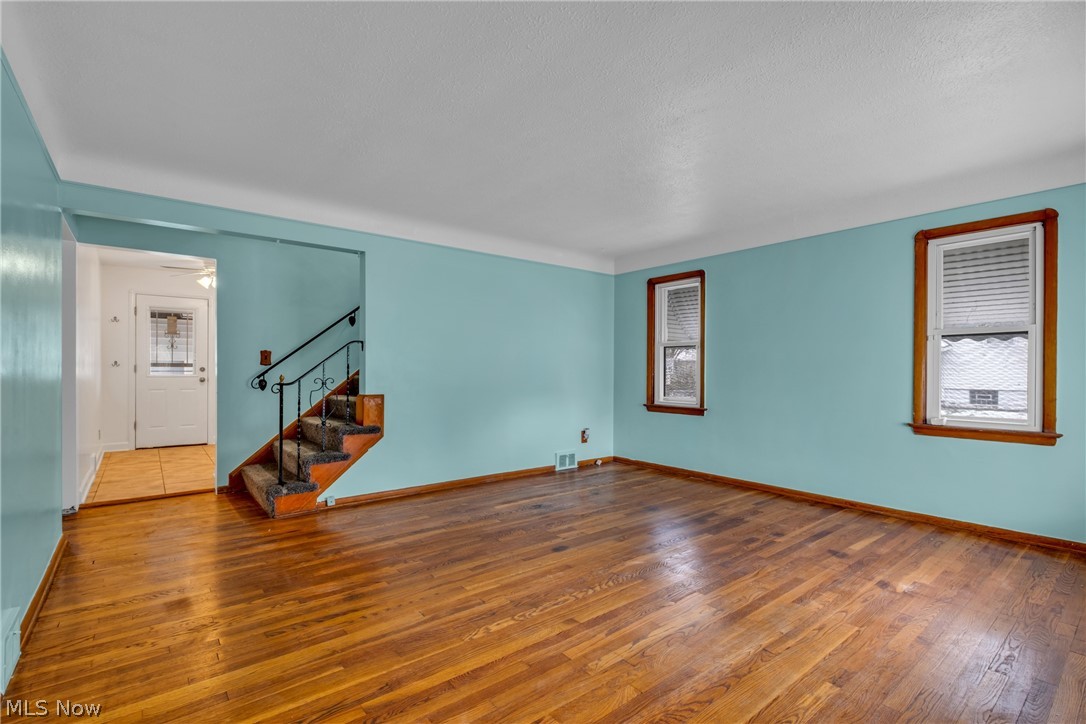 5731 Dunham Road Maple Heights, OH 44137 - Photo 5 of 28 Living room featuring plenty of natural light and dark hardwood / wood-style flooring