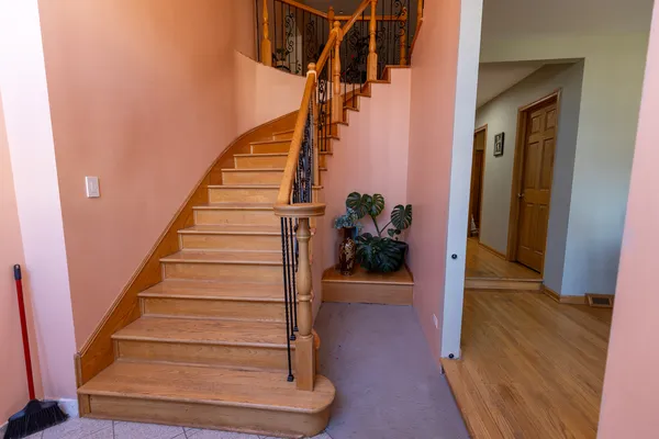 a view of entryway and hall with wooden floor