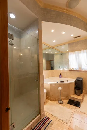 a bathroom with a sink a large mirror and a shower