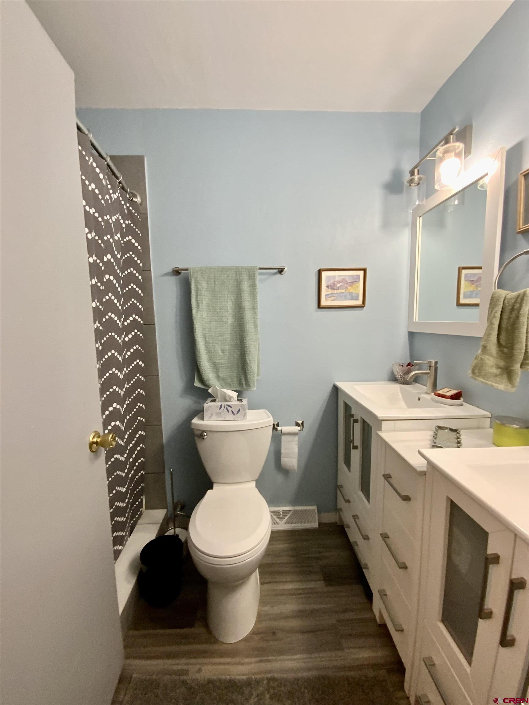 21 Vulcan Street Gunnison, CO 81230 - Photo 14 of 21 a bathroom with a toilet sink and mirror