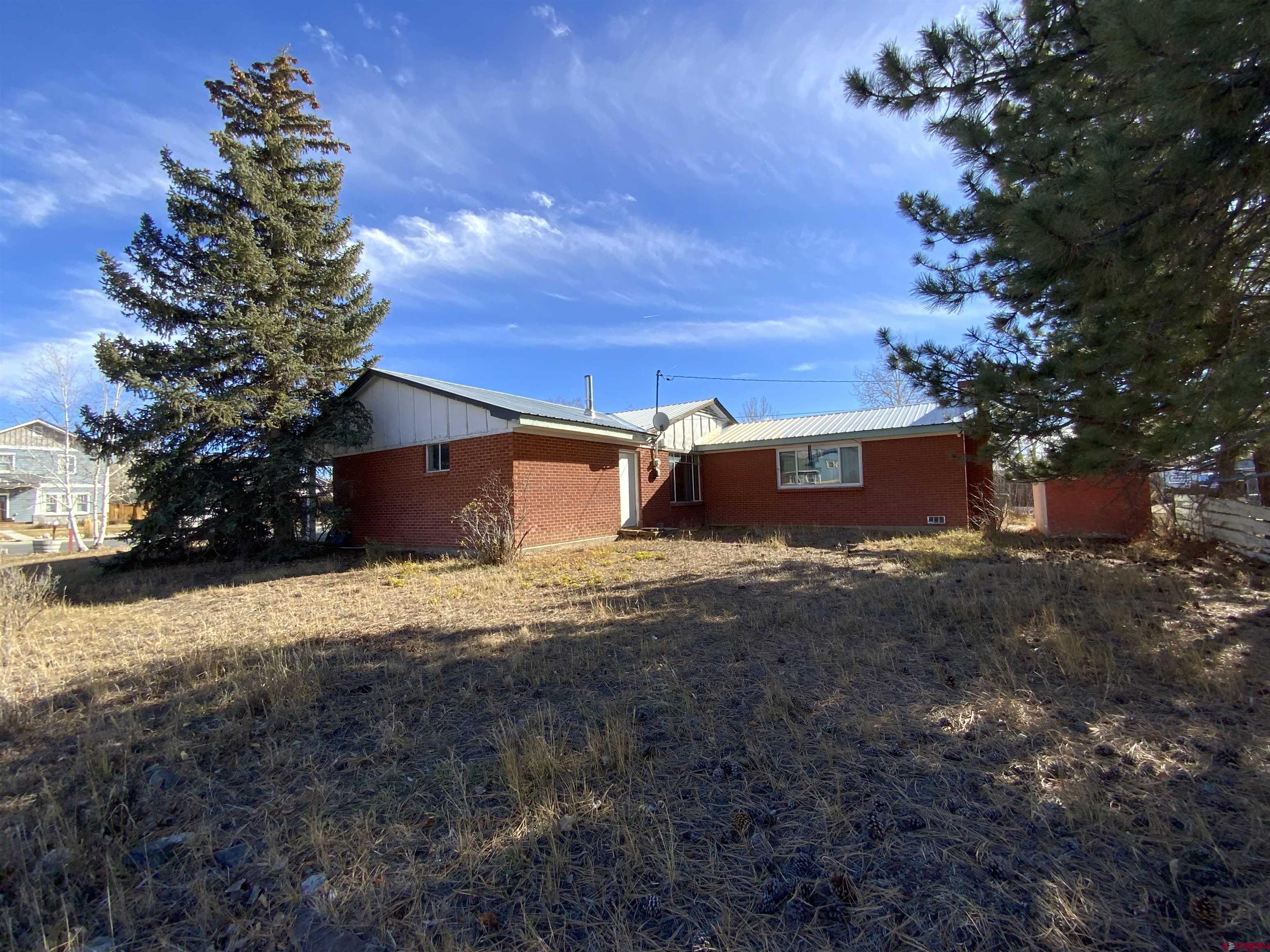 21 Vulcan Street Gunnison, CO 81230 - Photo 3 of 21 a view of a house with a yard