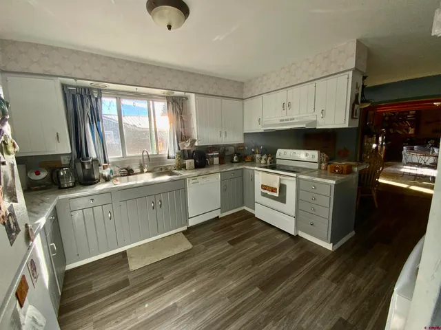 a kitchen with a stove a sink and a microwave