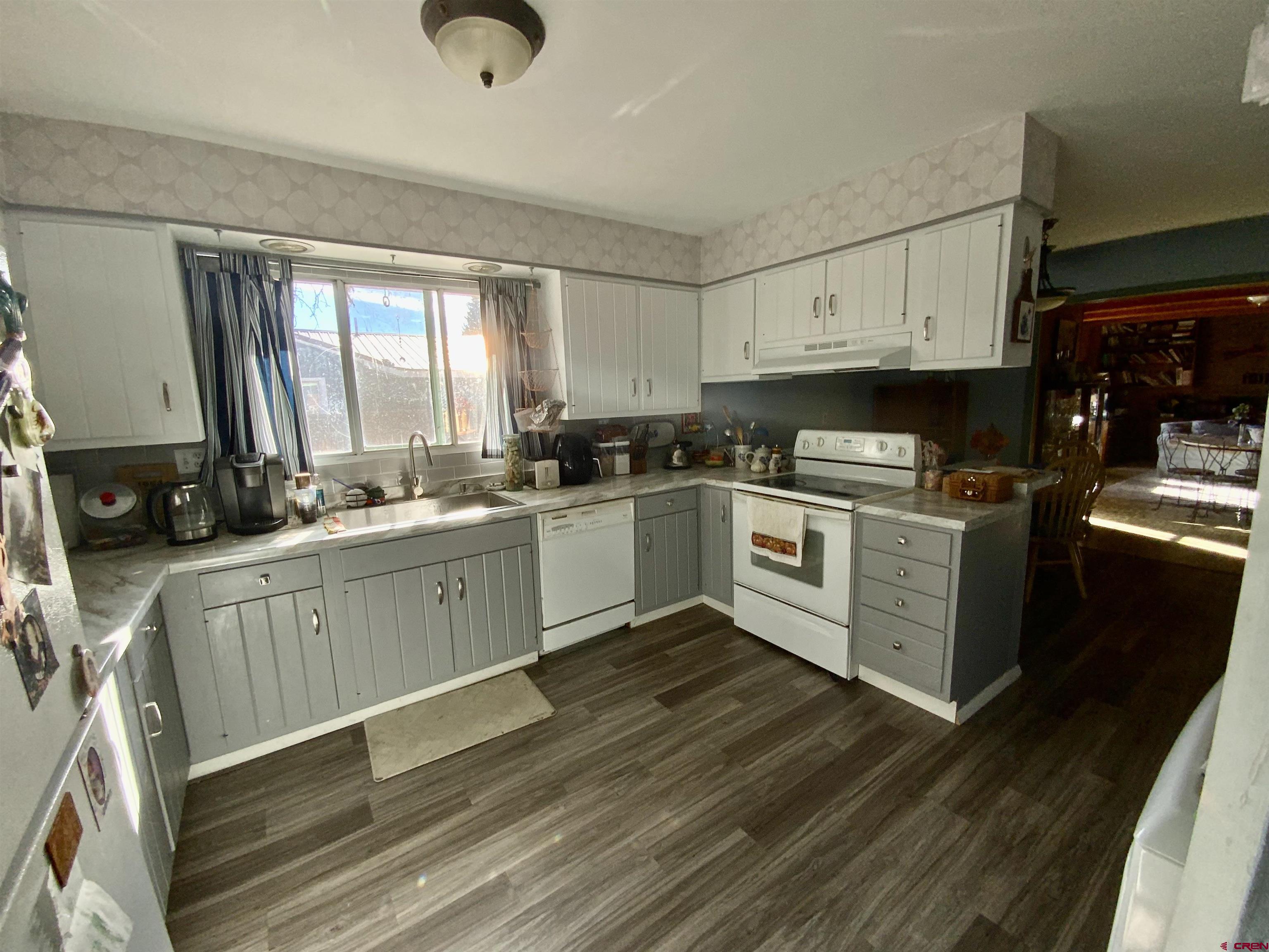 21 Vulcan Street Gunnison, CO 81230 - Photo 5 of 21 a kitchen with a stove a sink and a microwave